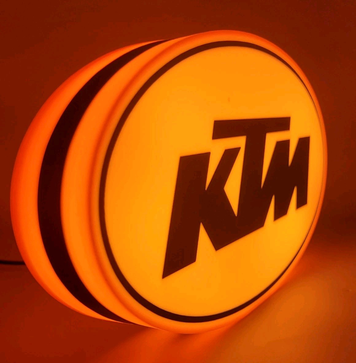 KTM led light sign with illuminated logo viewed from side view