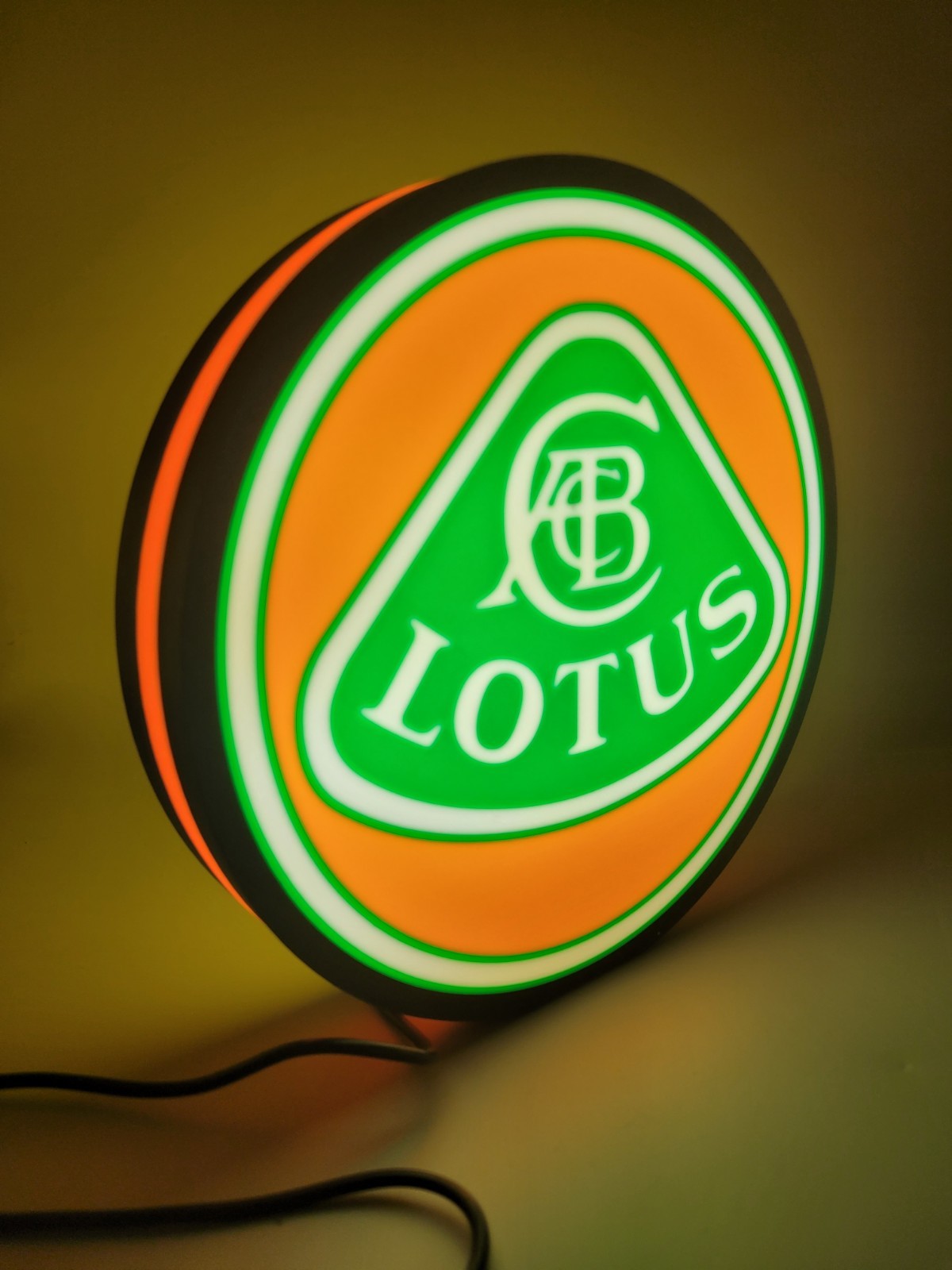 Lotus LED light sign with illuminated logo viewed from side view