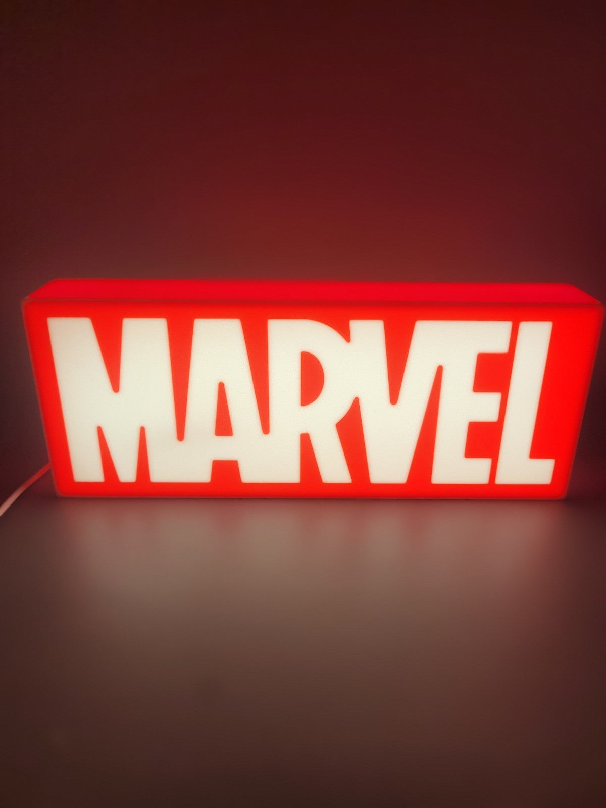 Marvel LED light sign with illuminated logo viewed from straight on