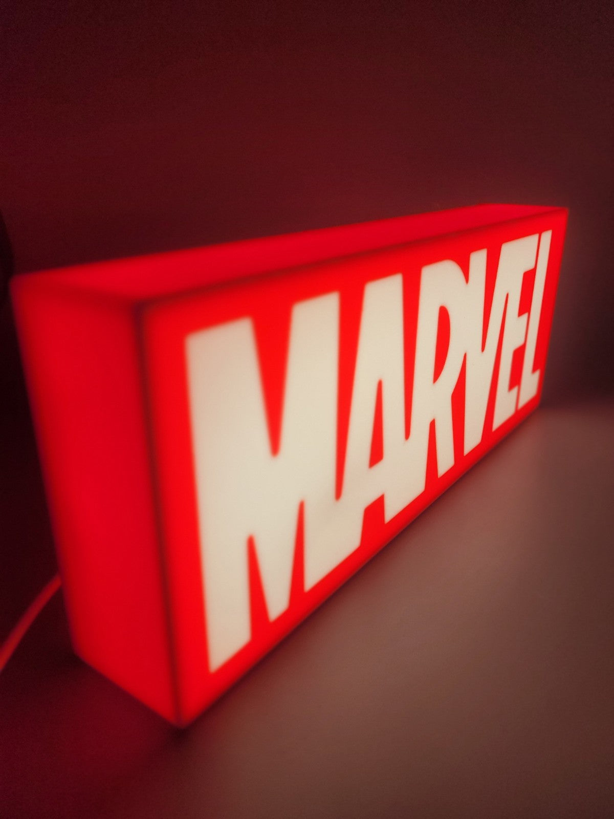Marvel LED light sign with illuminated logo viewed from side view