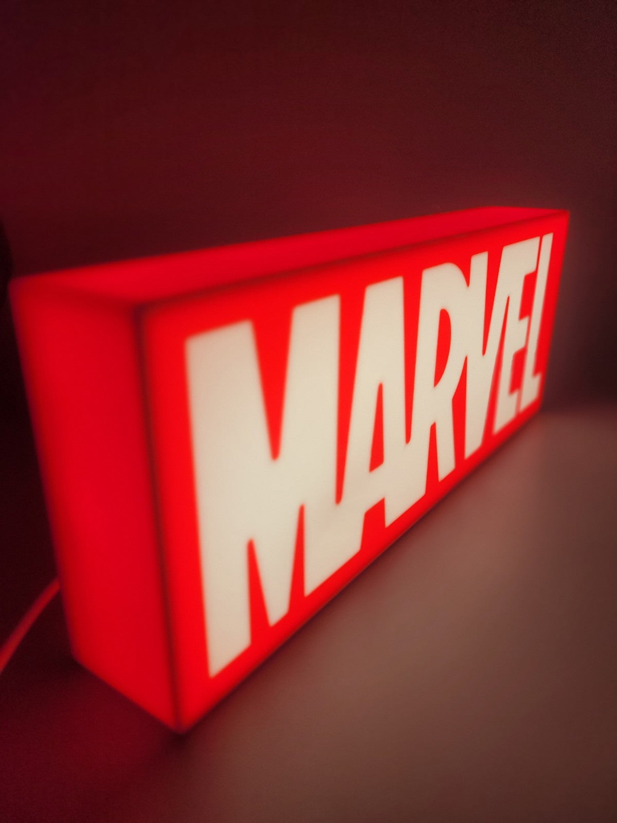 Marvel LED light sign with illuminated logo viewed from side view