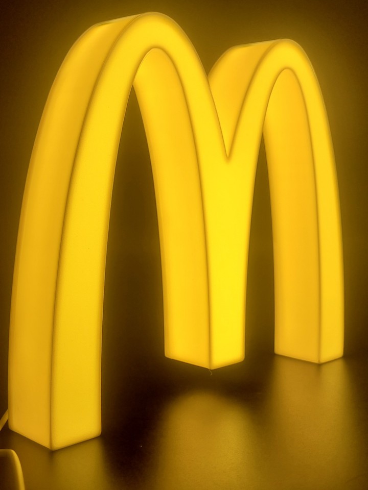 Mcdonald's LED light sign with illuminated logo viewed from side view