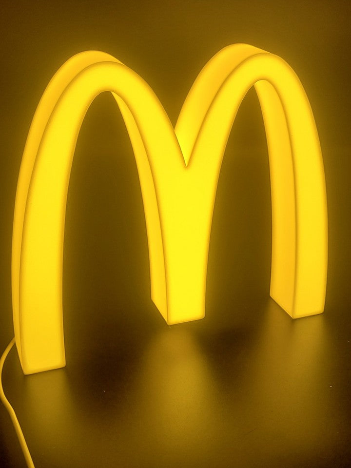 Mcdonald's LED light sign with illuminated logo viewed from side view