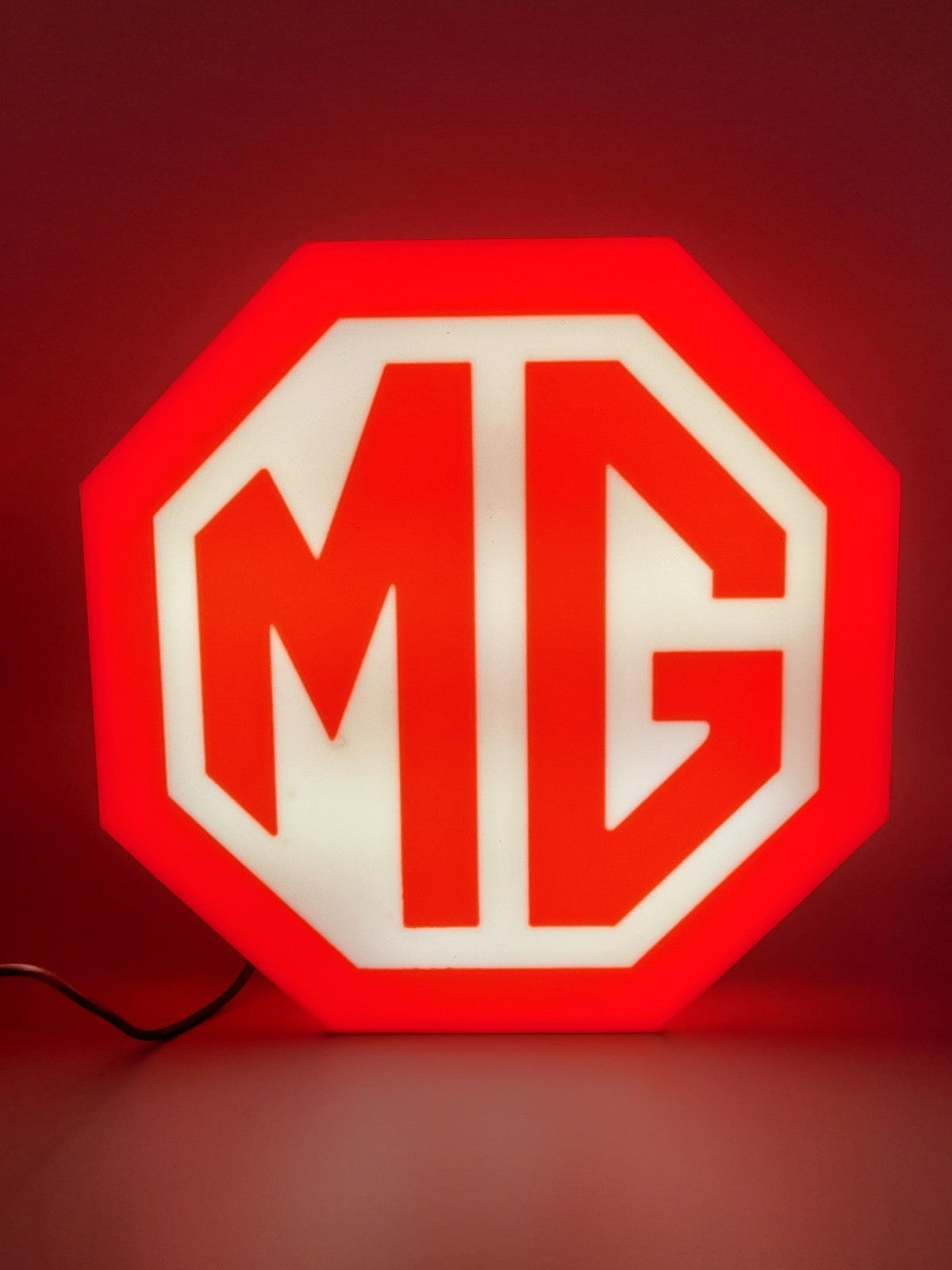 MG led light sign with illuminated logo viewed from straight on