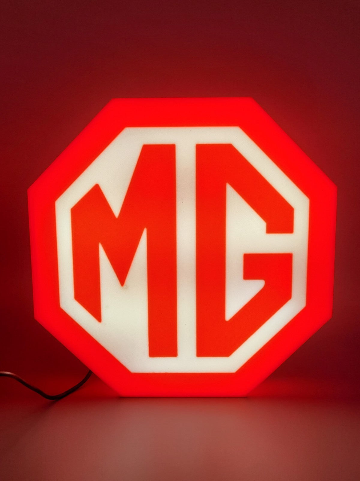 MG led light sign with illuminated logo viewed from straight on