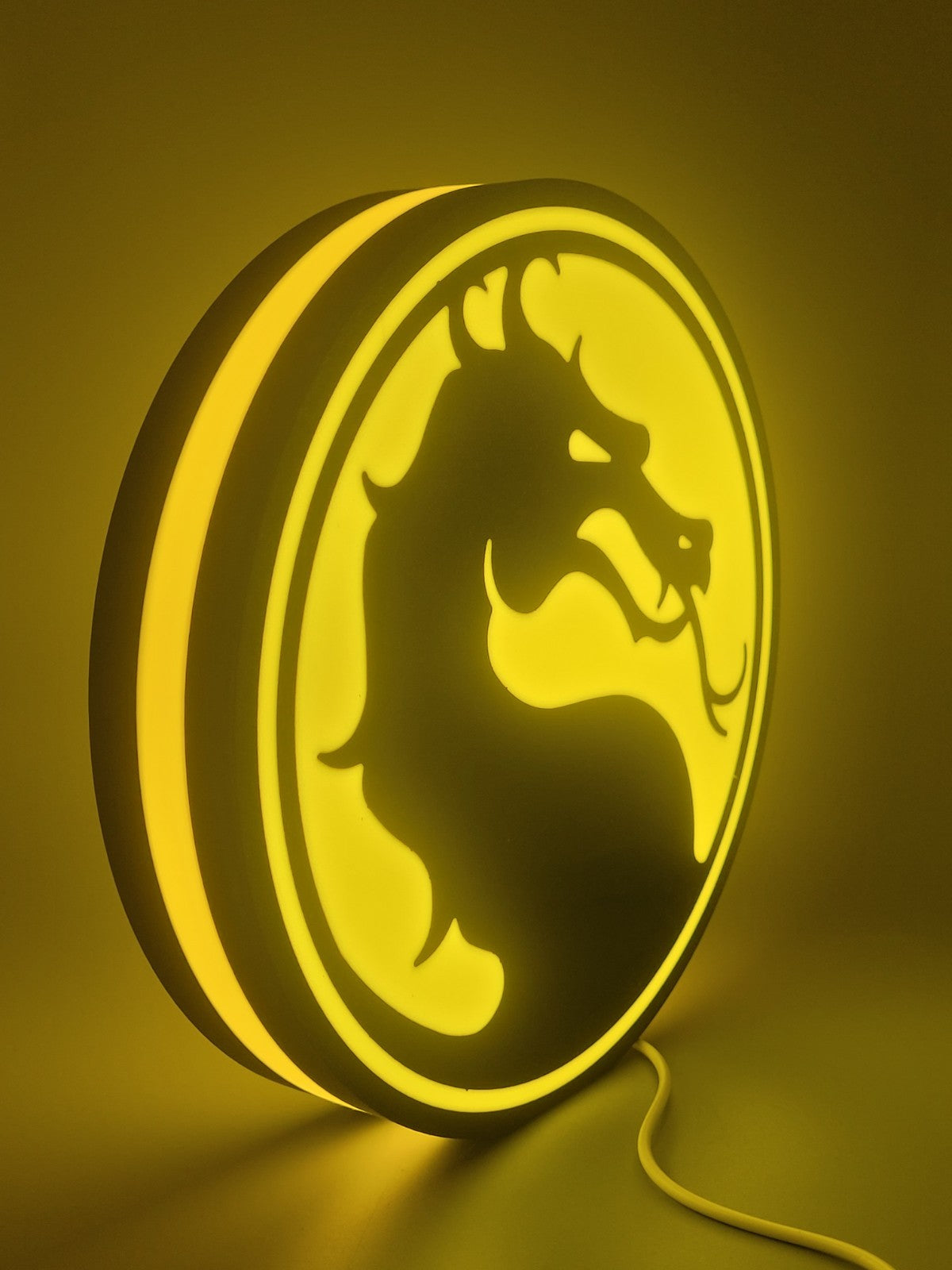 Mortal Kombat led light sign with illuminated logo viewed from side view