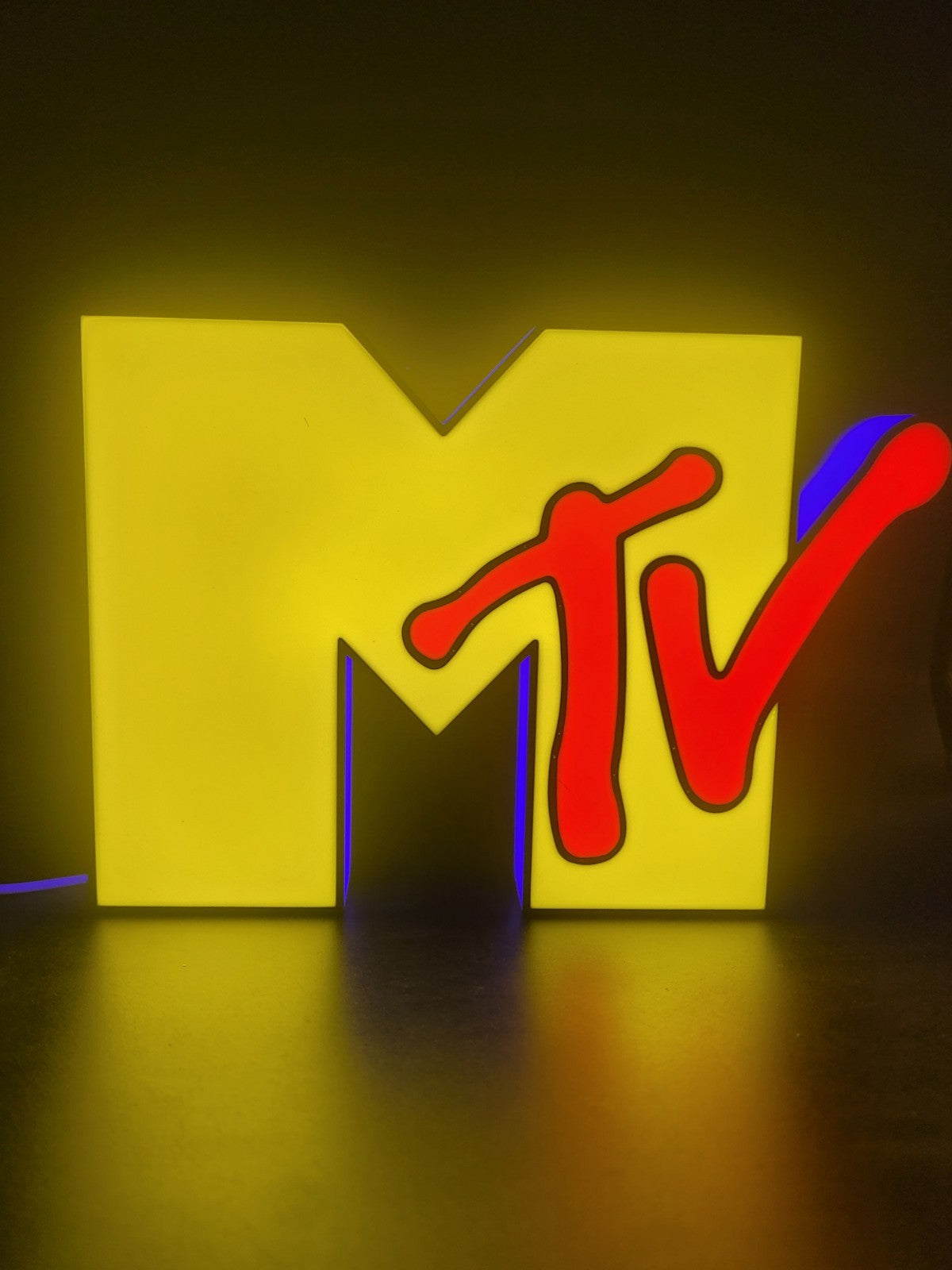 Mtv led light sign with illuminated logo viewed from straight on