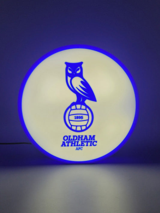 Oldham athletic AFC led light sign with illuminated logo viewed from straight on