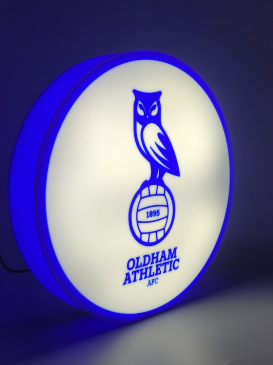 Oldham athletic AFC led light sign with illuminated logo viewed from side view