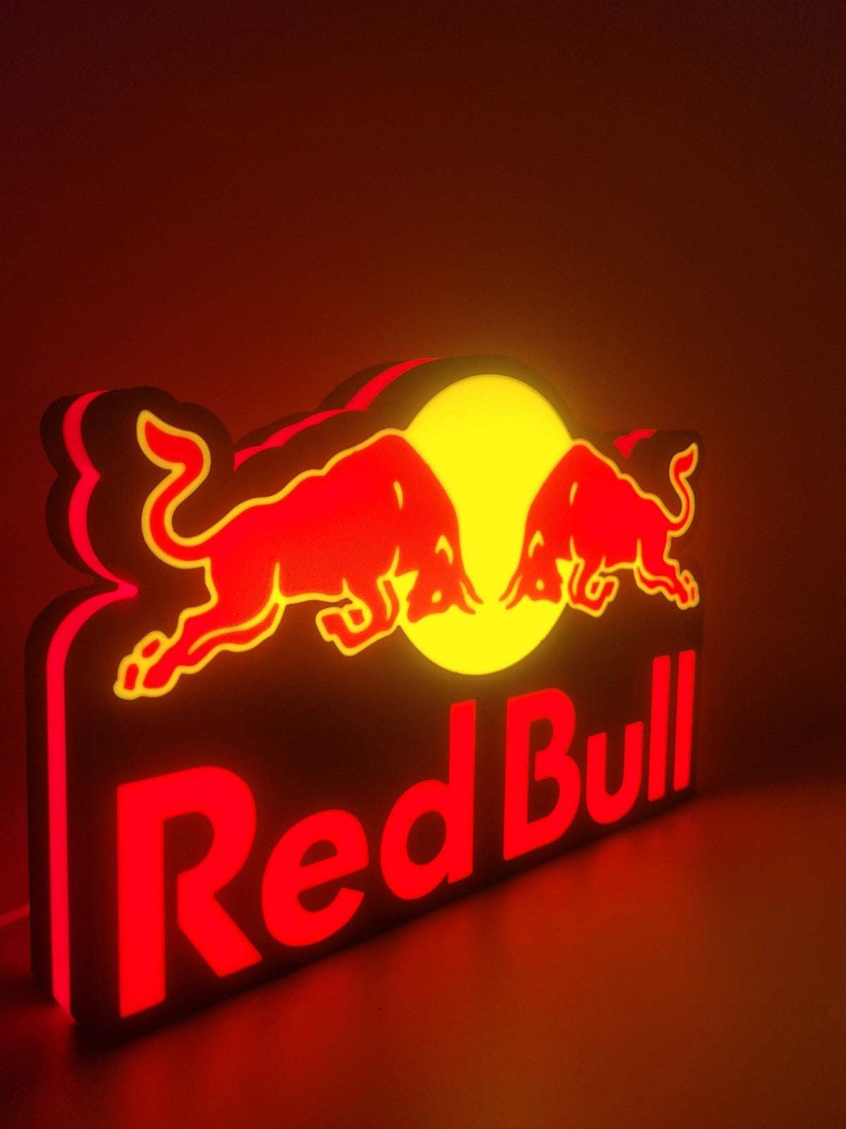Redbull led light sign with illuminated logo viewed from side view