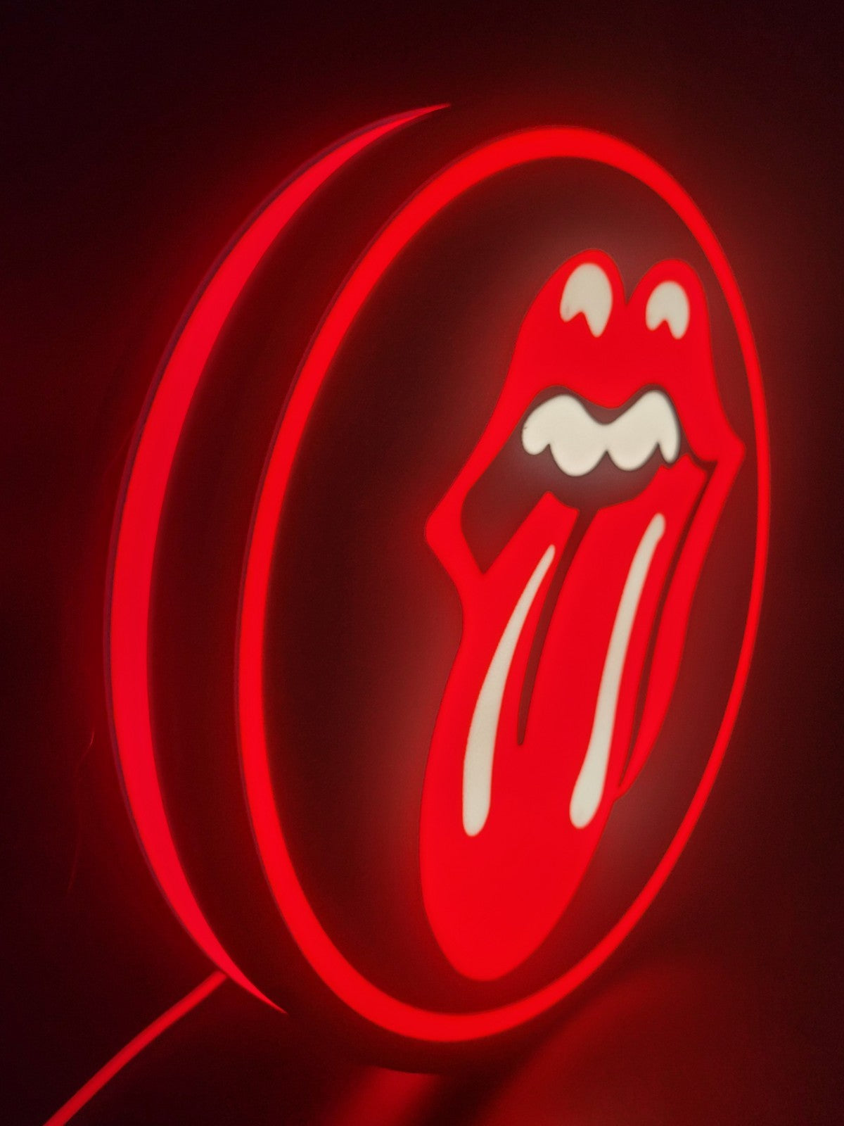 Rollingstones LED light sign with illuminated logo viewed from side view