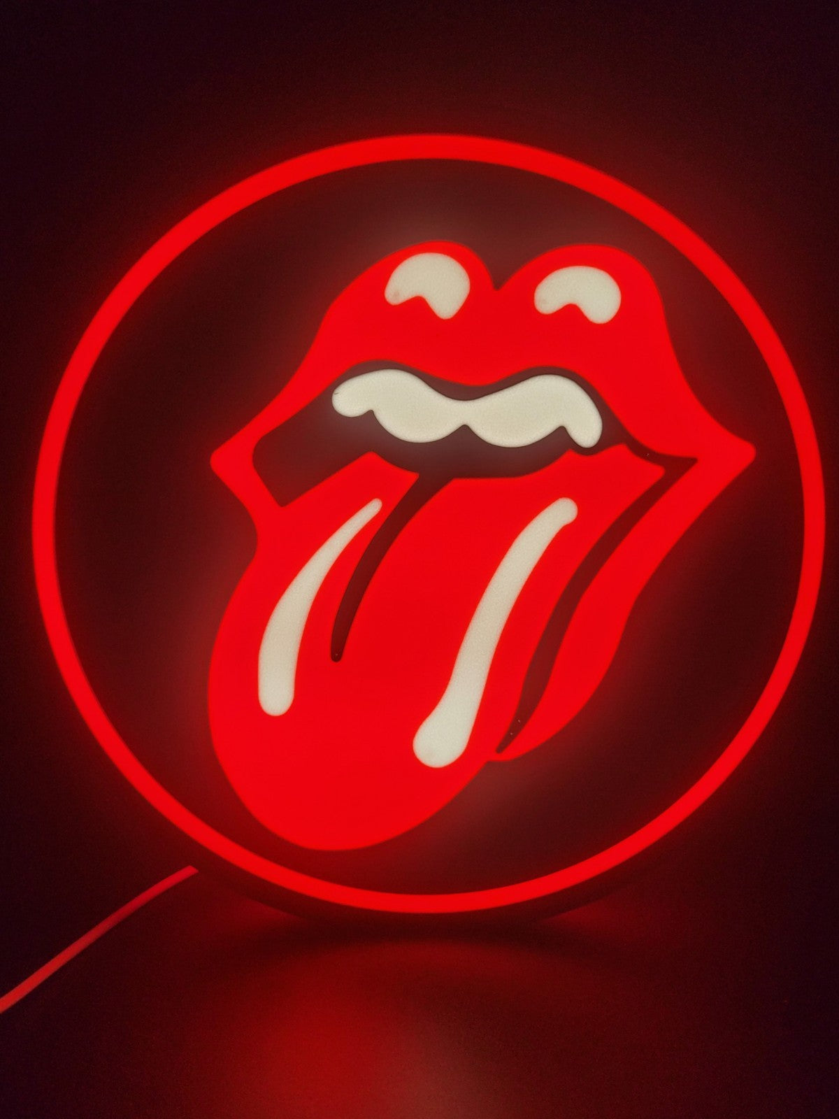 rolling stones led light sign with illuminated logo viewed from straight on