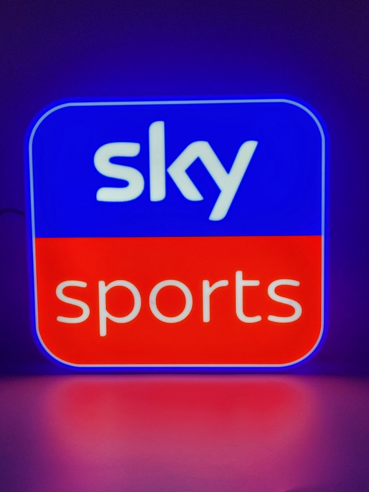 sky sports led light sign with illuminated logo viewed from straight on