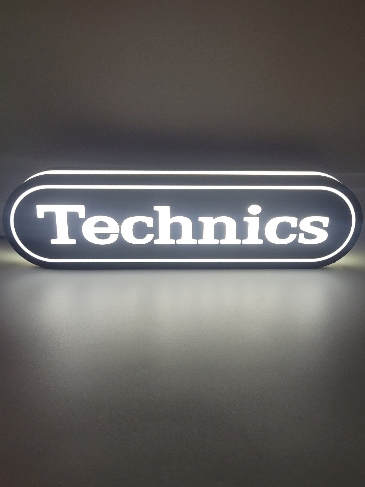 Technics LED light sign with illuminated logo viewed from straight on