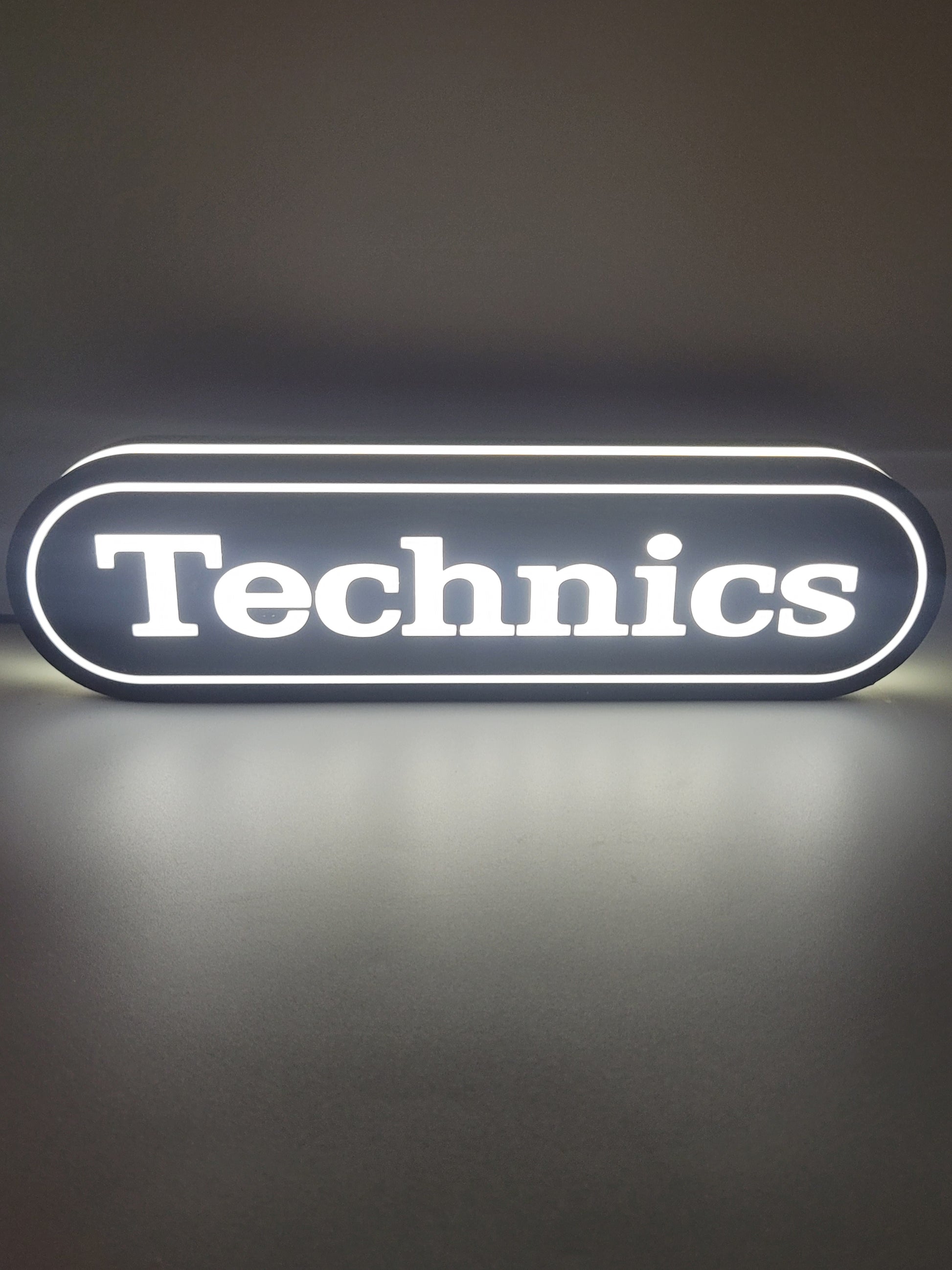 Technics LED light sign with illuminated logo viewed from straight on