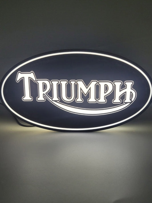 Triumph led light sign with illuminated logo viewed from straight on