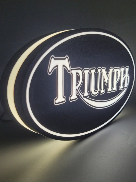 Triumph led light sign with illuminated logo viewed from side view