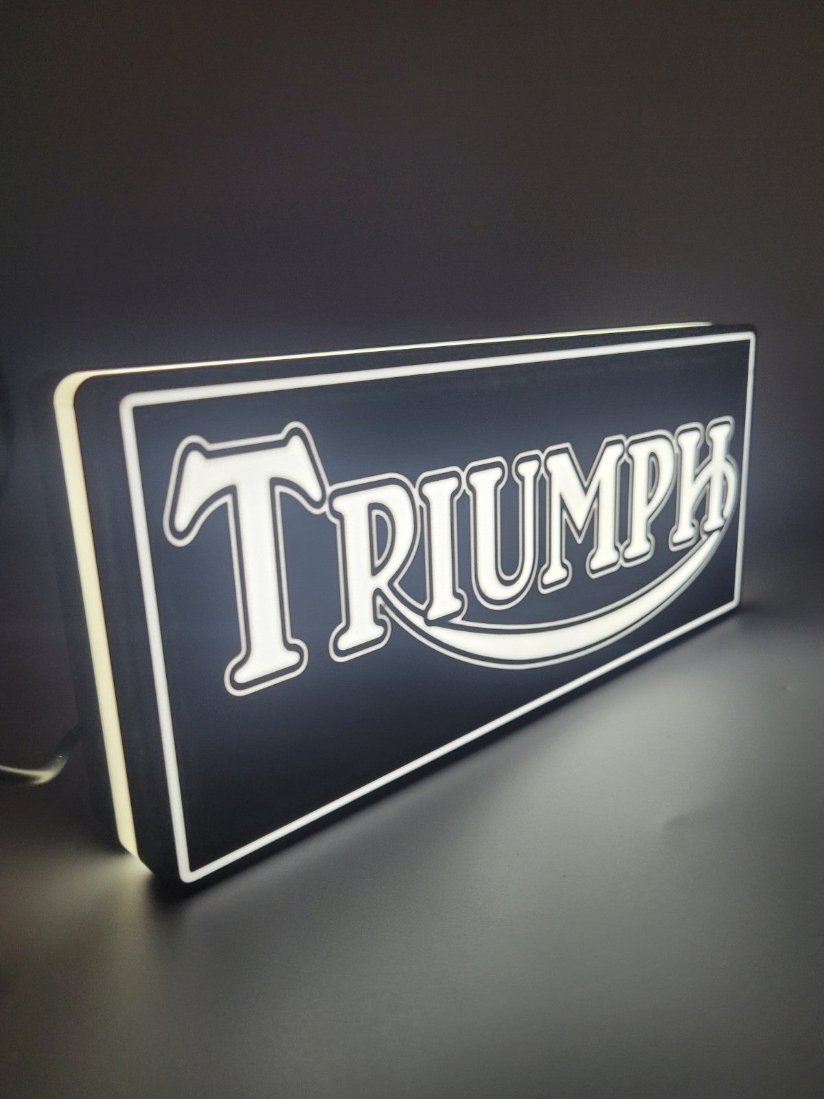 TRIUMPH LED light sign with illuminated logo viewed from side view