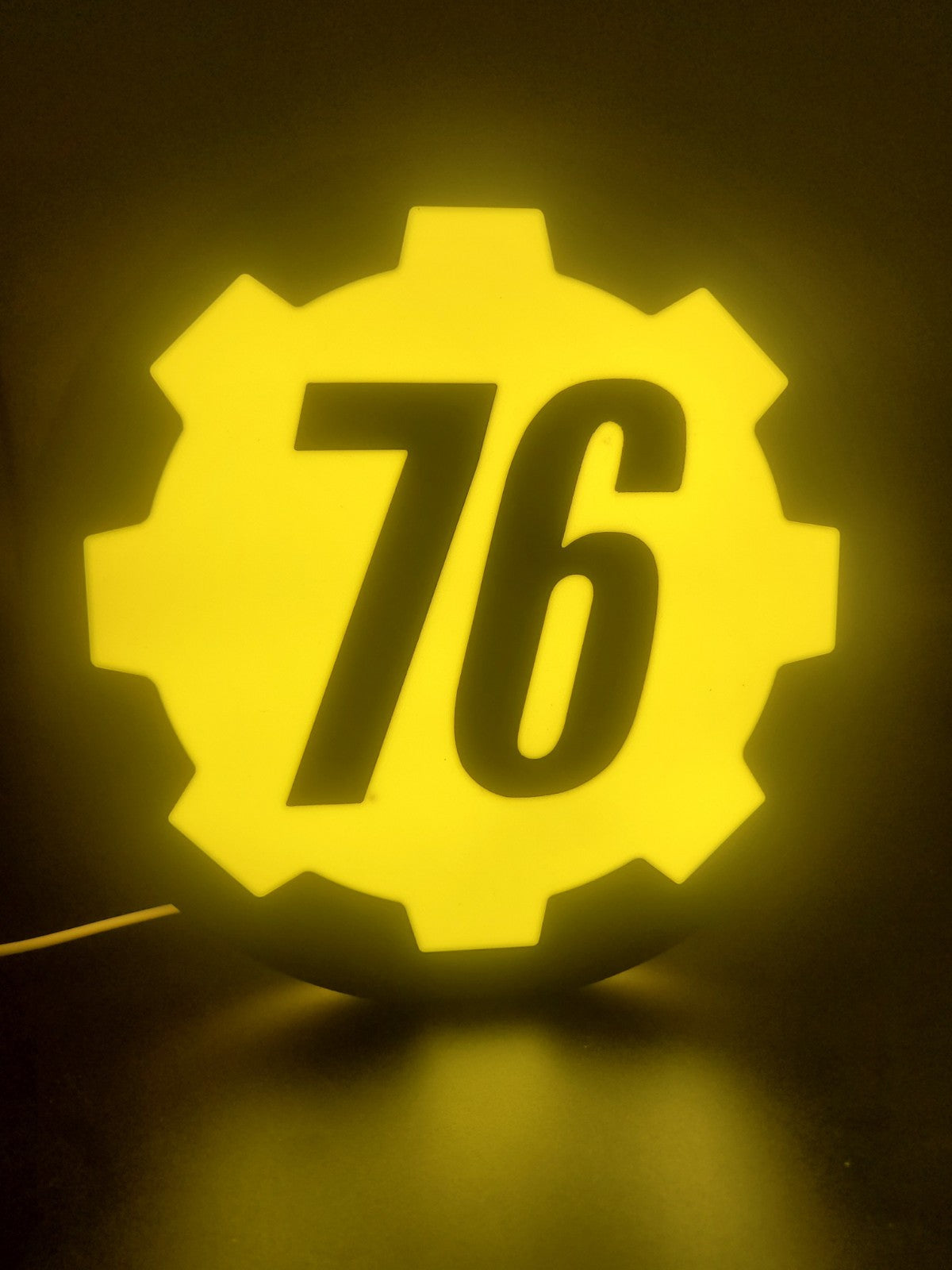 Vault 76 LED light sign with illuminated logo viewed from straight on