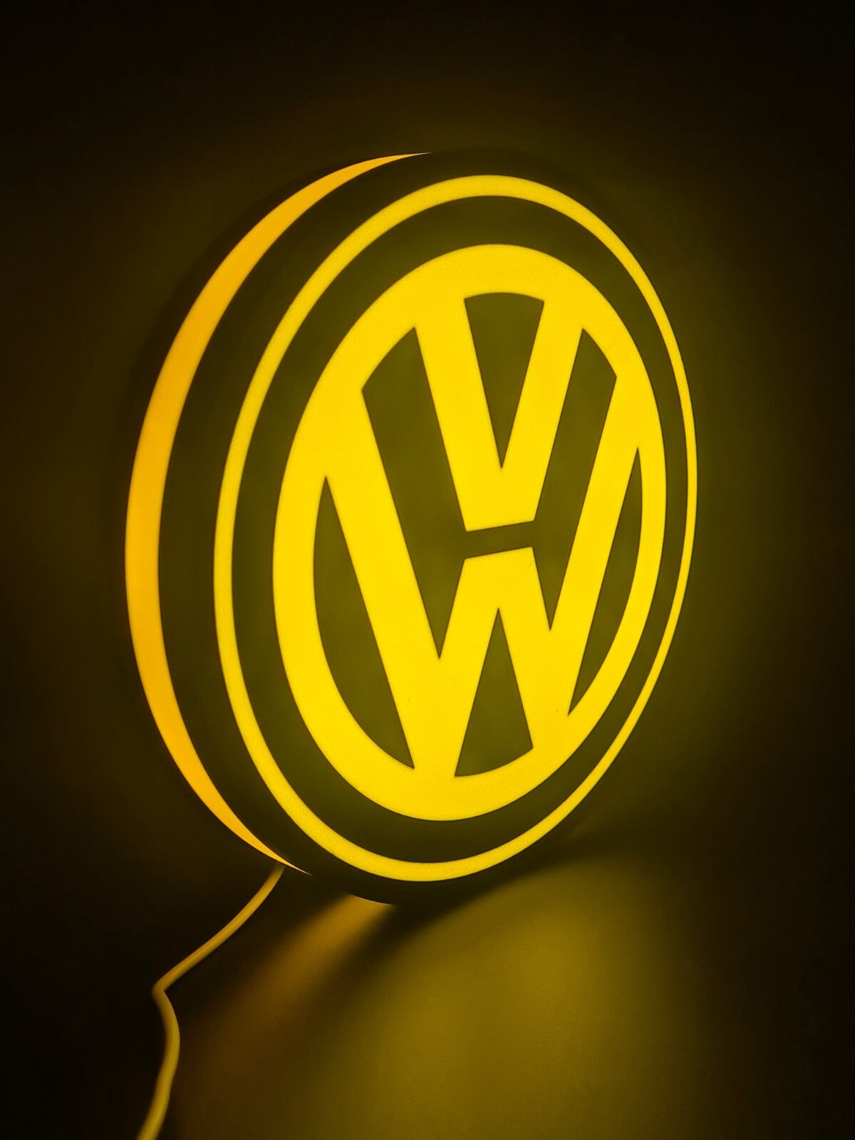 Volkswagen LED light sign with illuminated logo viewed from side view
