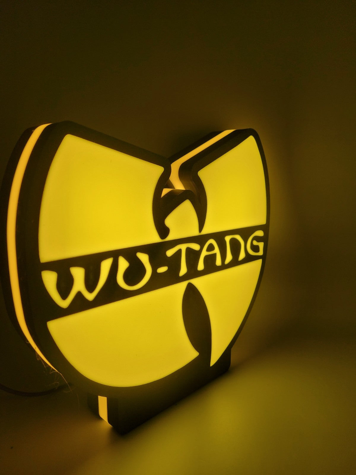 Wu-tang led light sign with illuminated logo viewed from side view