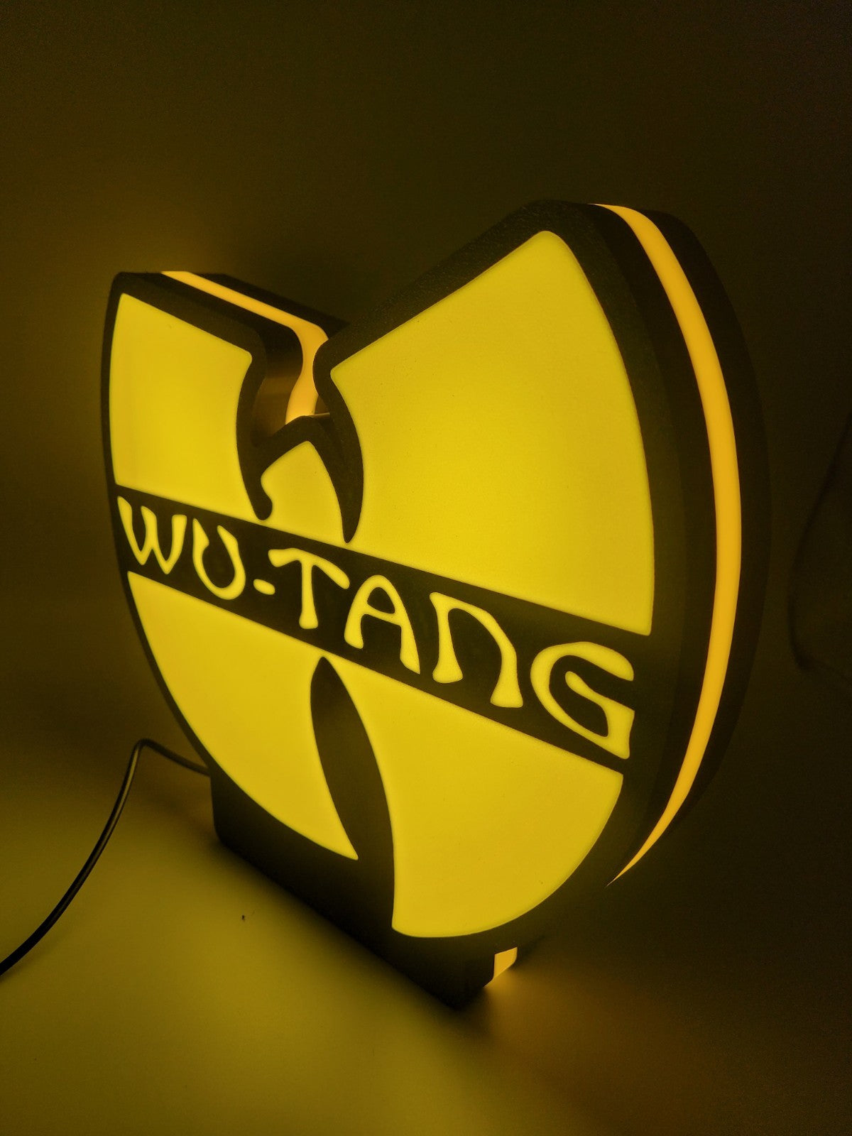 Wu-tang led light sign with illuminated logo viewed from side view