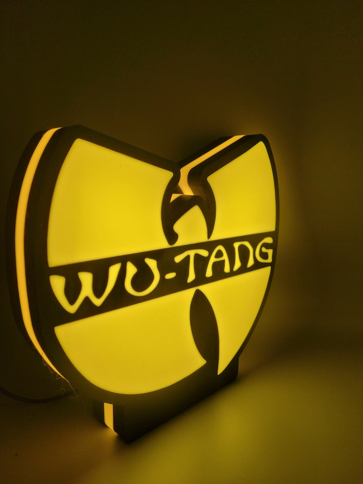 Wu-tang led light sign with illuminated logo viewed from side view