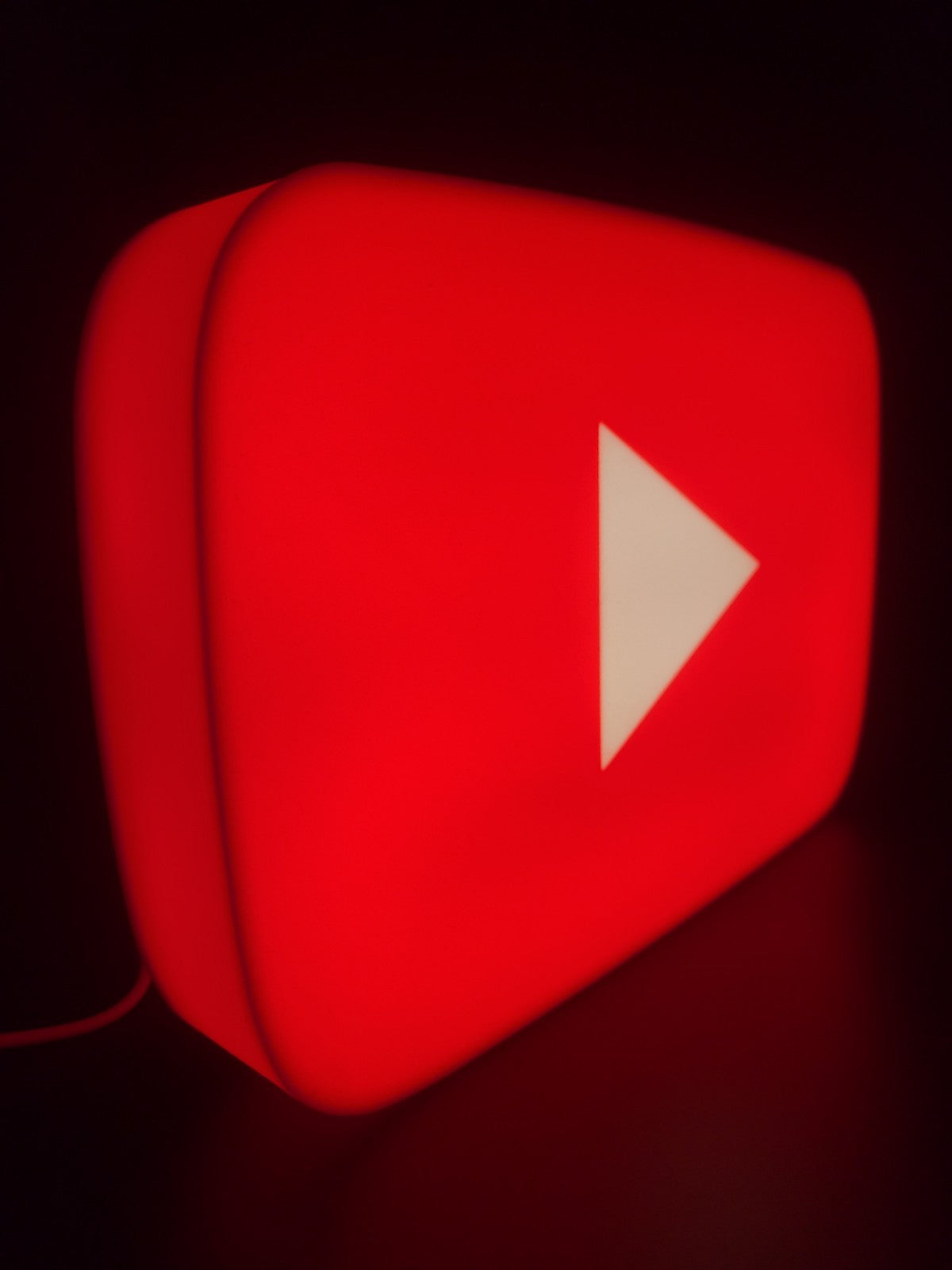 Youtube LED light sign with illuminated logo viewed from side view